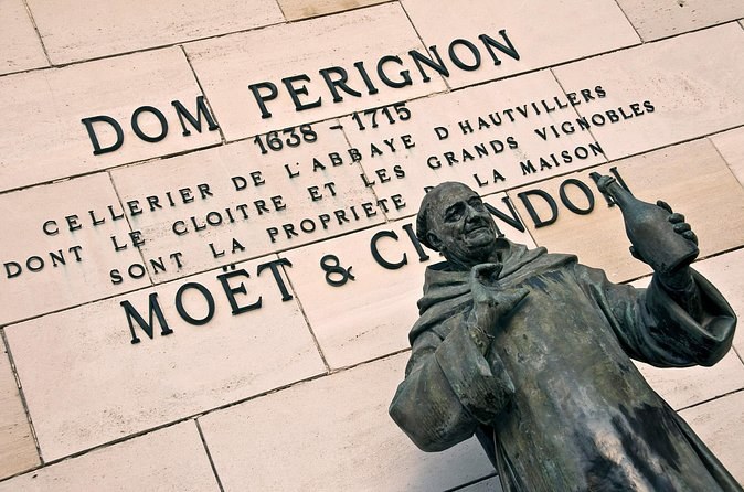 The statue of Dom Pérignon, cellar master of Hautvillers abbey, before a carved inscription
