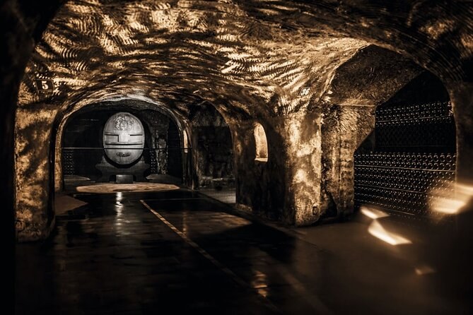 A great carved cask at the end of a lit cellar gallery