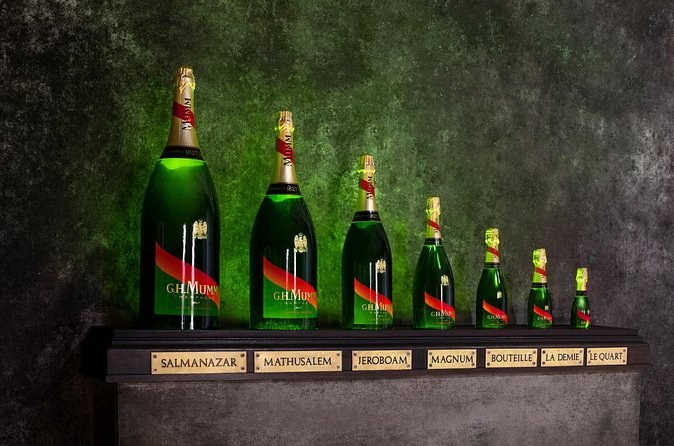 A row of G.H. Mumm bottles from the quarter bottle up to the Salmanazar, each labelled