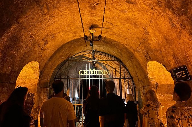 The iron gate of the G.H. Mumm cellars under a vaulted chalk ceiling